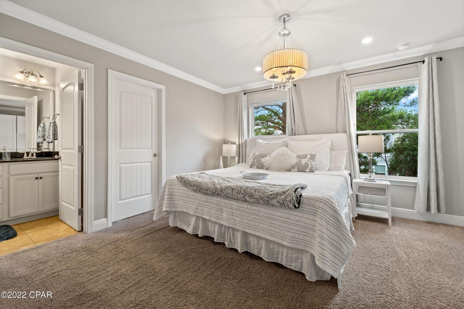 11 Topside Drive Inlet Beach, FL 32461 - Photo 21 of 31 a bedroom with a bed and a chandelier