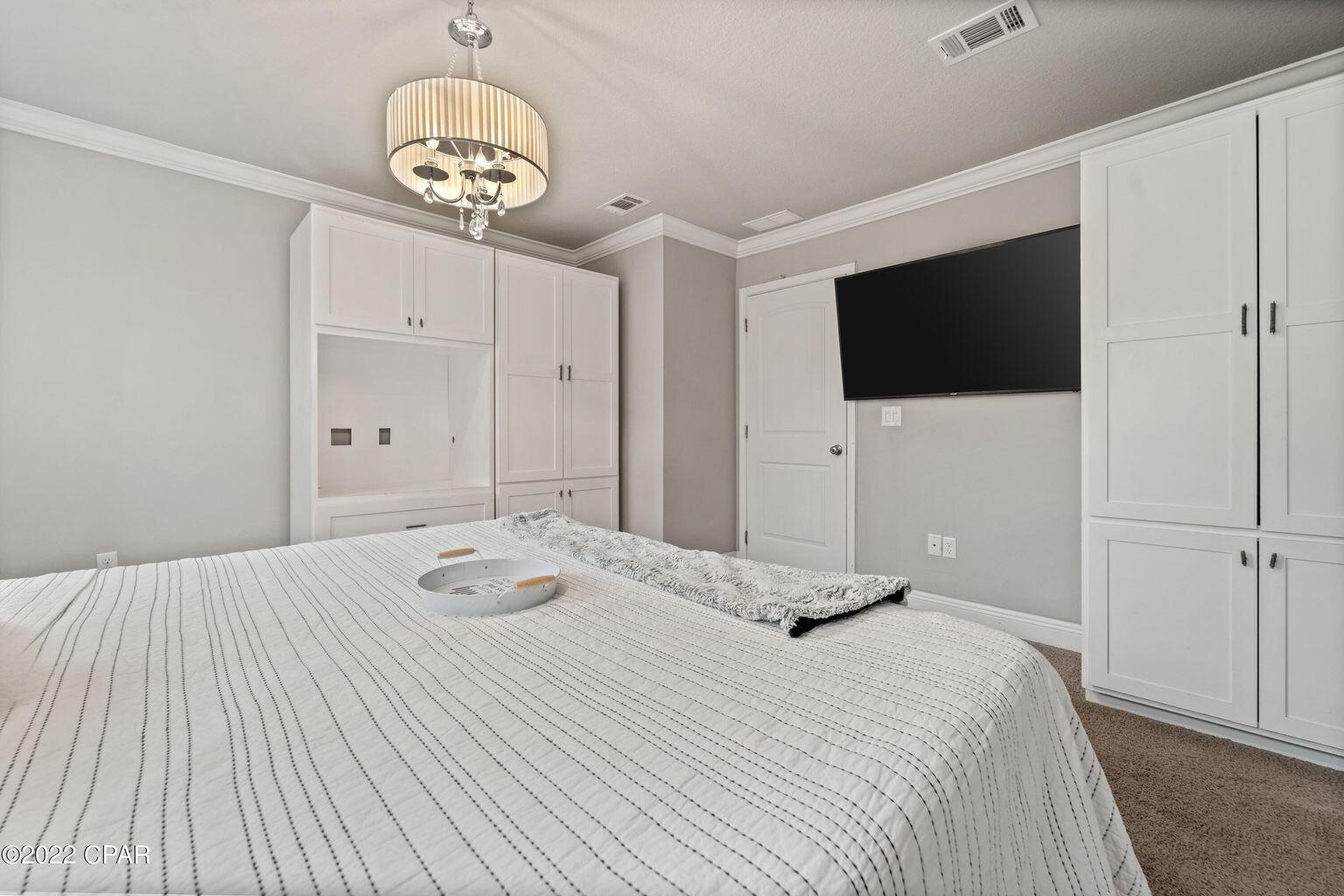 11 Topside Drive Inlet Beach, FL 32461 - Photo 4 of 31 a bedroom with a bed and a flat tv screen on dresser