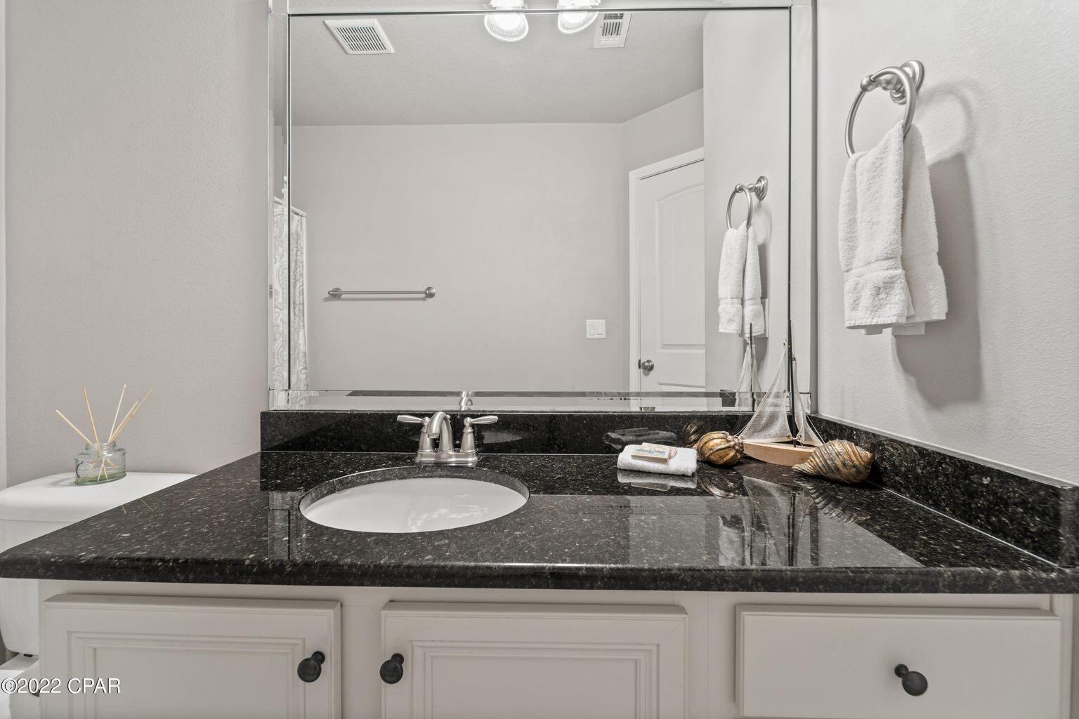 11 Topside Drive Inlet Beach, FL 32461 - Photo 7 of 31 a bathroom with a granite countertop sink and a mirror