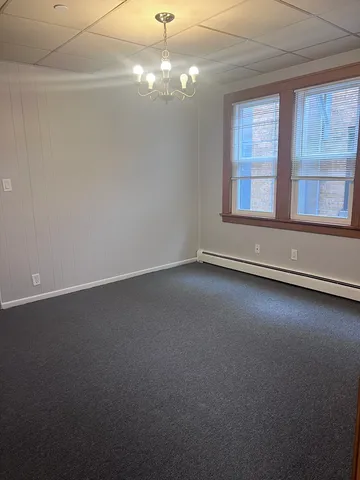 an empty room with a empty space and windows