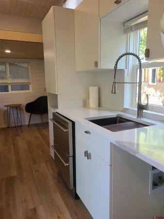 a kitchen with a sink a stove and cabinets