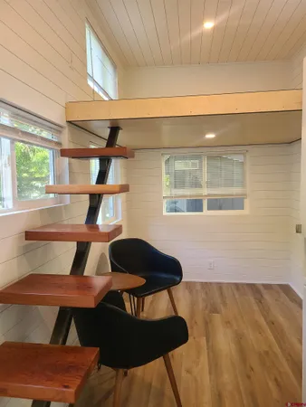 a front view of a house with table & chairs