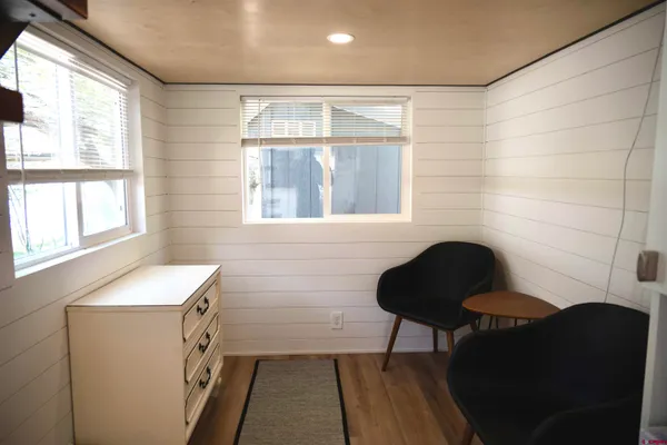 a view of a room with furniture and a window