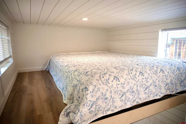 a bed sitting in a room next to a window