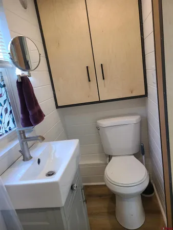 a bathroom with a sink a toilet and mirror