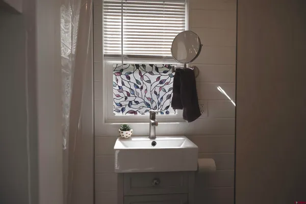 a bathroom with a sink and mirror