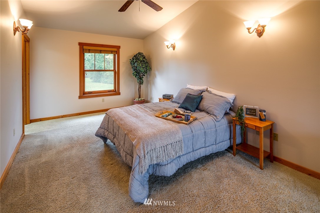 6570 North Star Road Ferndale, WA 98248 - Photo 13 of 39 a bedroom with a bed table and window