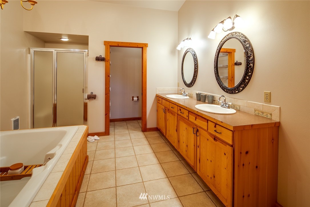 6570 North Star Road Ferndale, WA 98248 - Photo 15 of 39 a bathroom with a mirror and a sink