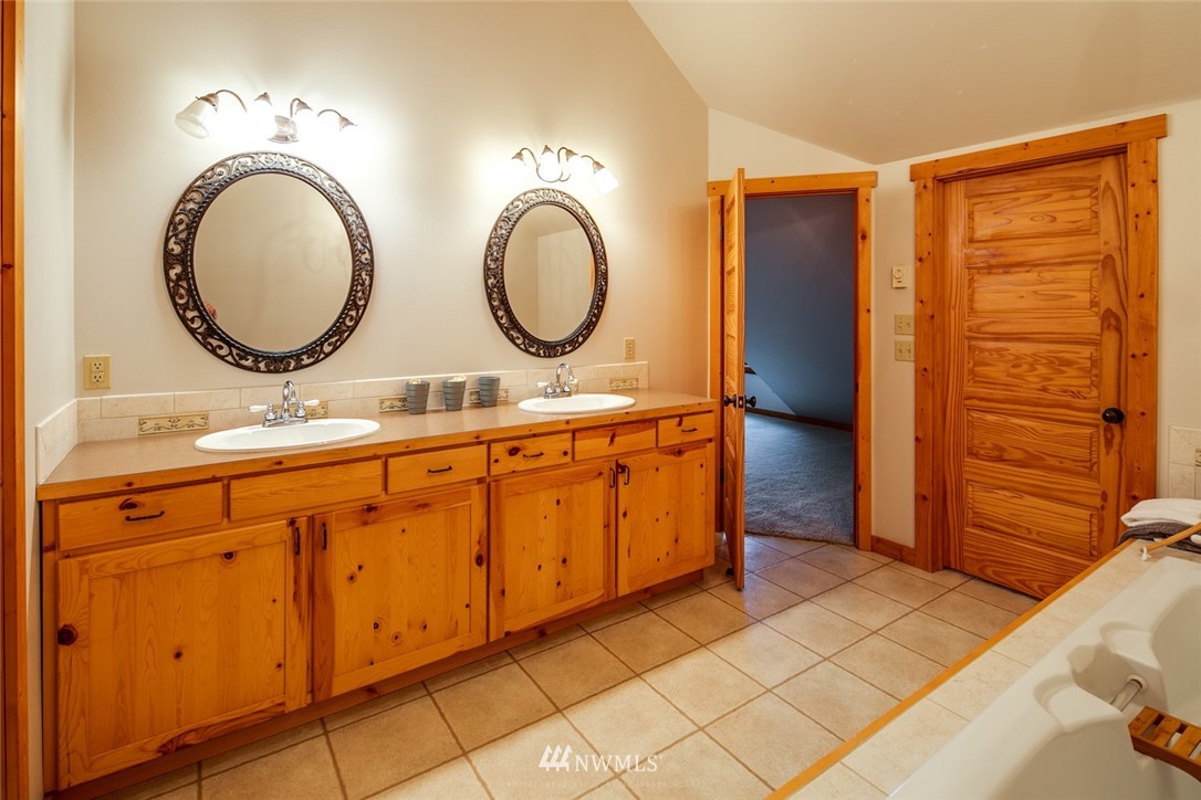 6570 North Star Road Ferndale, WA 98248 - Photo 16 of 39 a bathroom with a sink a mirror and a shower