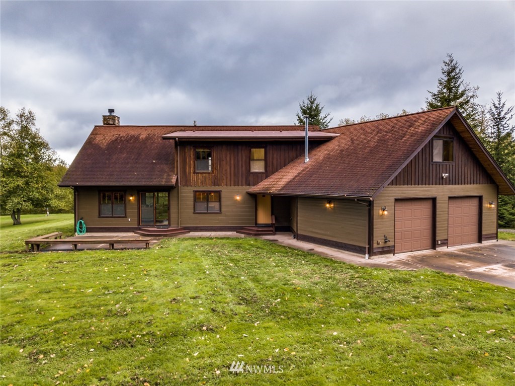 6570 North Star Road Ferndale, WA 98248 - Photo 32 of 39 a front view of house with yard and trees in the background