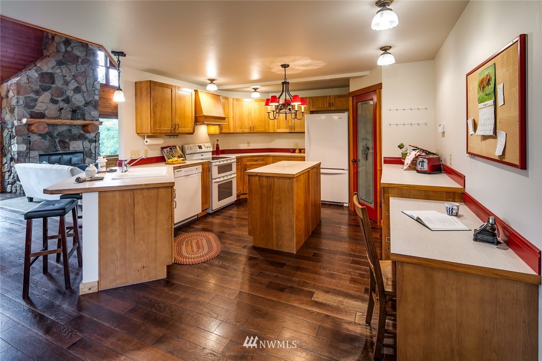 6570 North Star Road Ferndale, WA 98248 - Photo 8 of 39 a kitchen with kitchen island wooden floors and stainless steel appliances