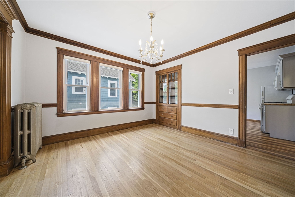 104 Greaton Road, Unit 2 Boston, MA 02132 - Photo 5 of 32 a view of livingroom with hardwood floor and a kitchen