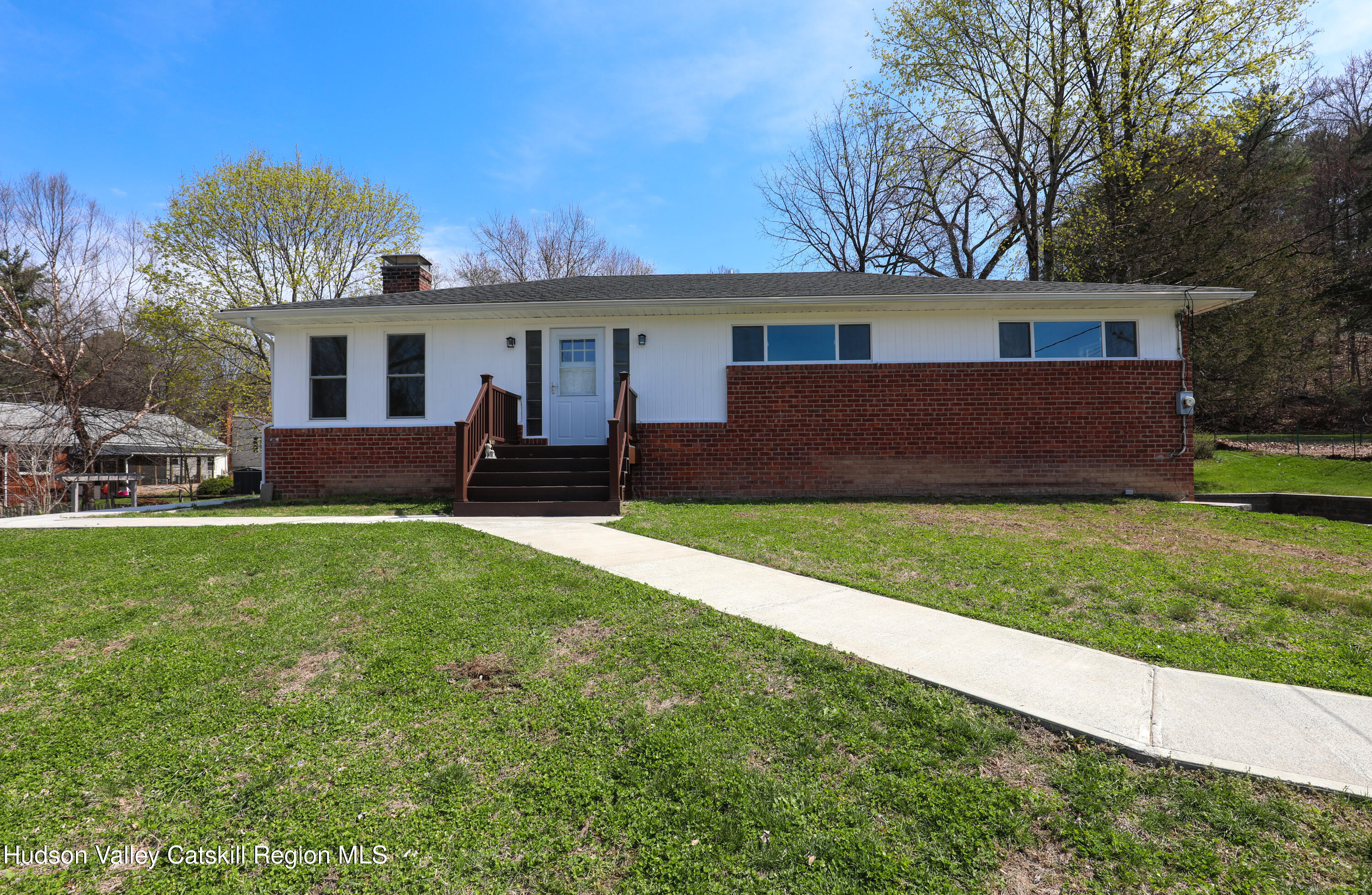a front view of house with yard and green space
