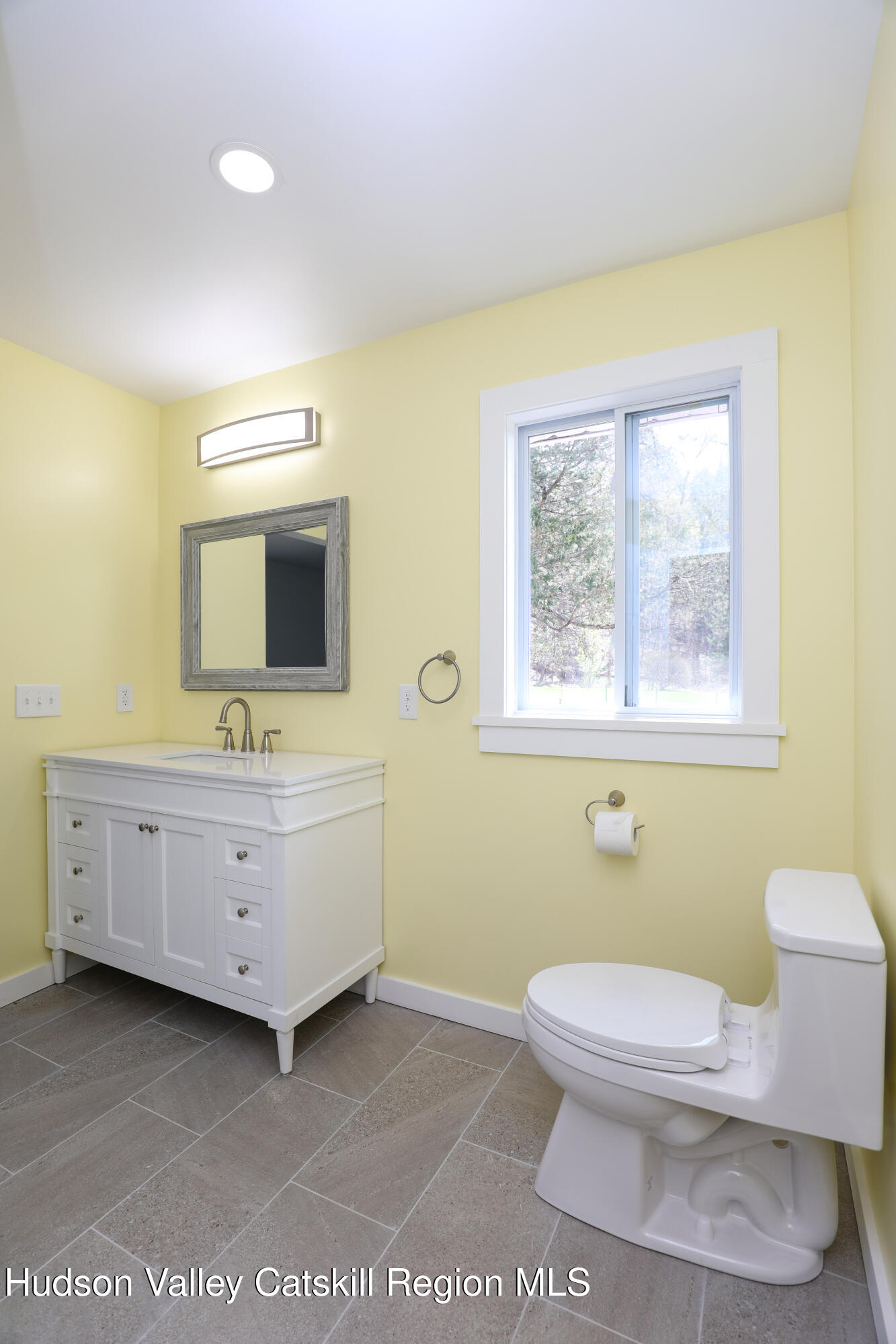 111 Zandhoek Road Hurley, NY 12443 - Photo 13 of 33 a bathroom with a toilet a sink a mirror and a window