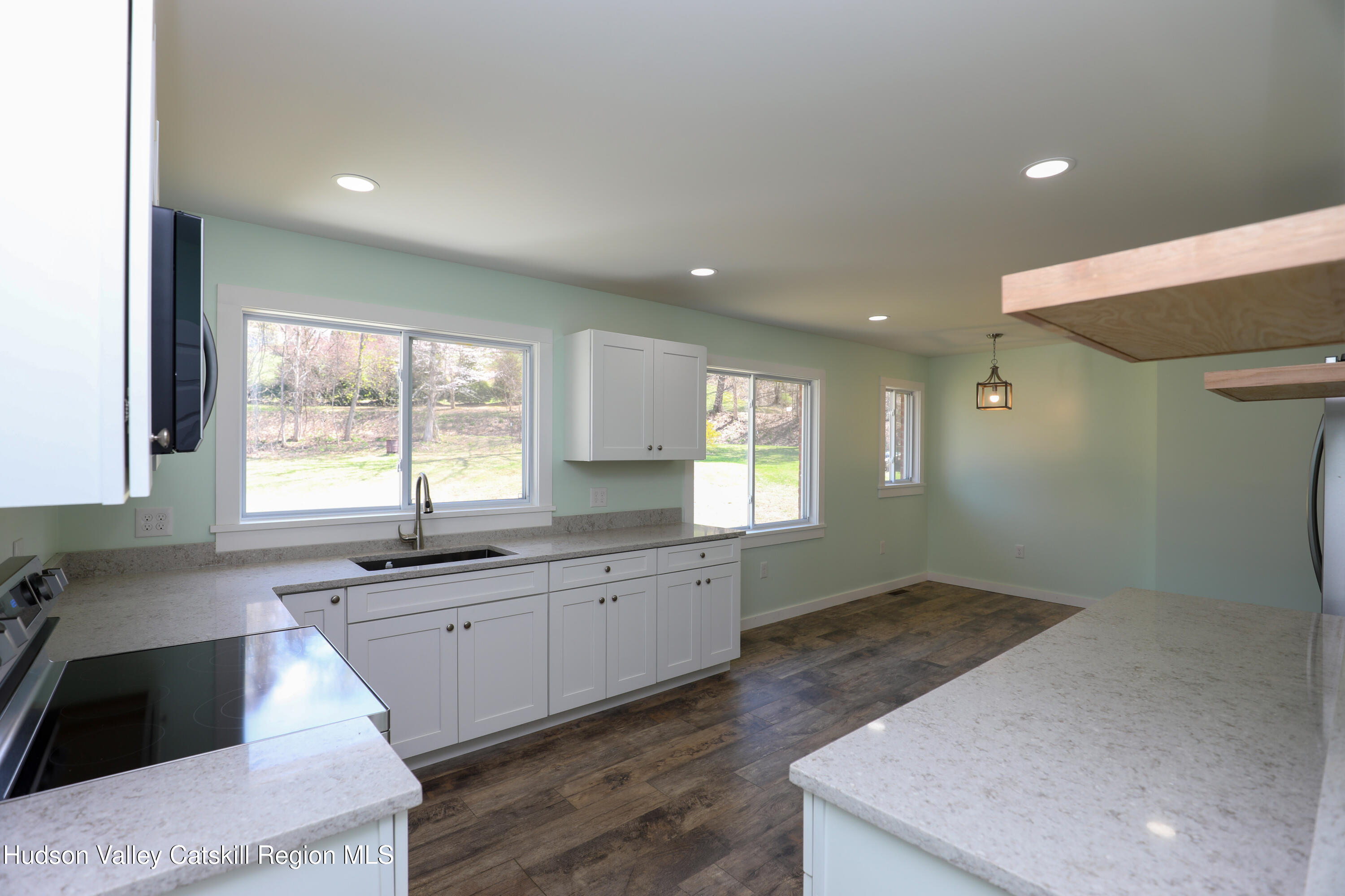 111 Zandhoek Road Hurley, NY 12443 - Photo 21 of 33 a large kitchen with granite countertop a sink window and cabinets