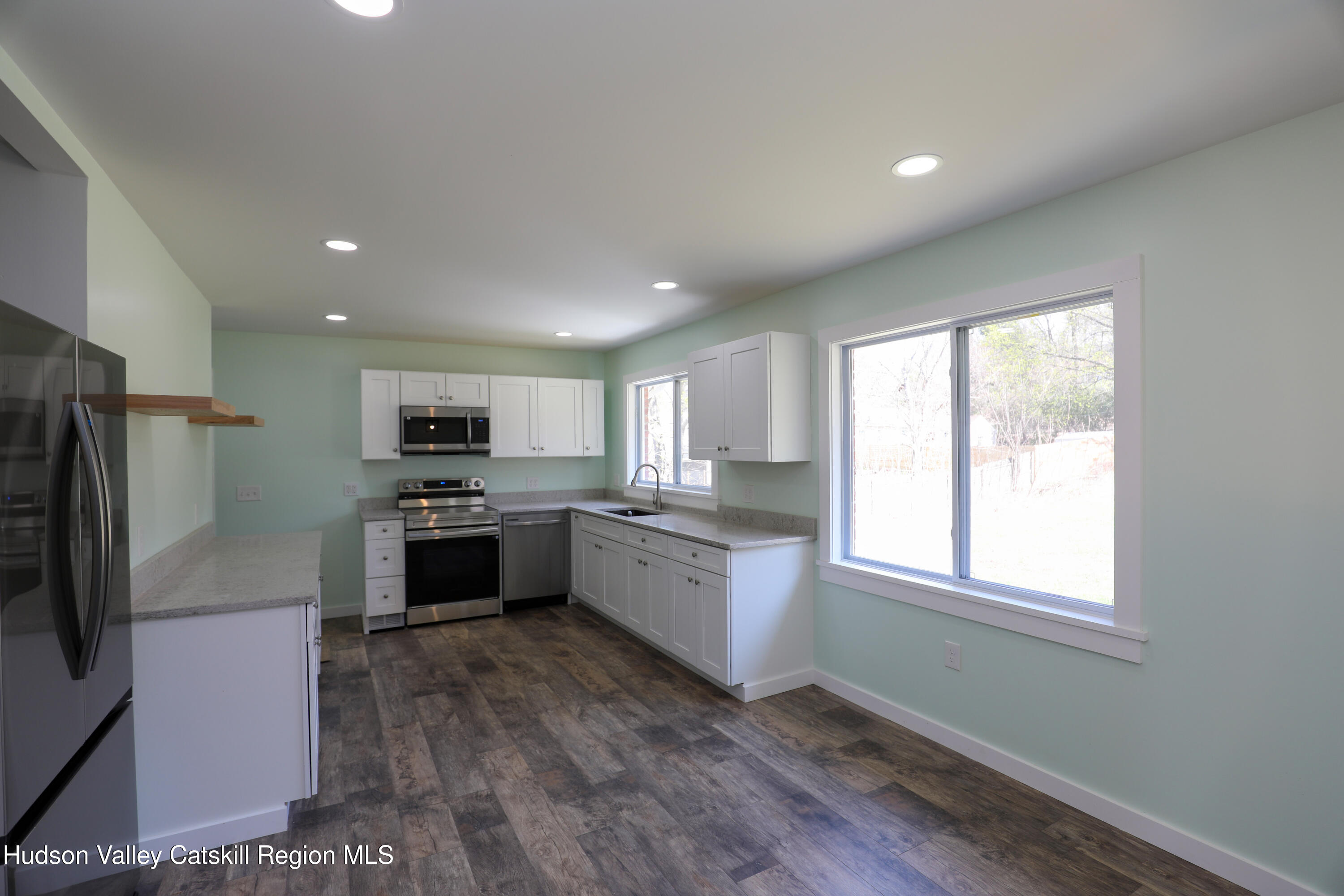 111 Zandhoek Road Hurley, NY 12443 - Photo 23 of 33 a large kitchen with a large window and stainless steel appliances