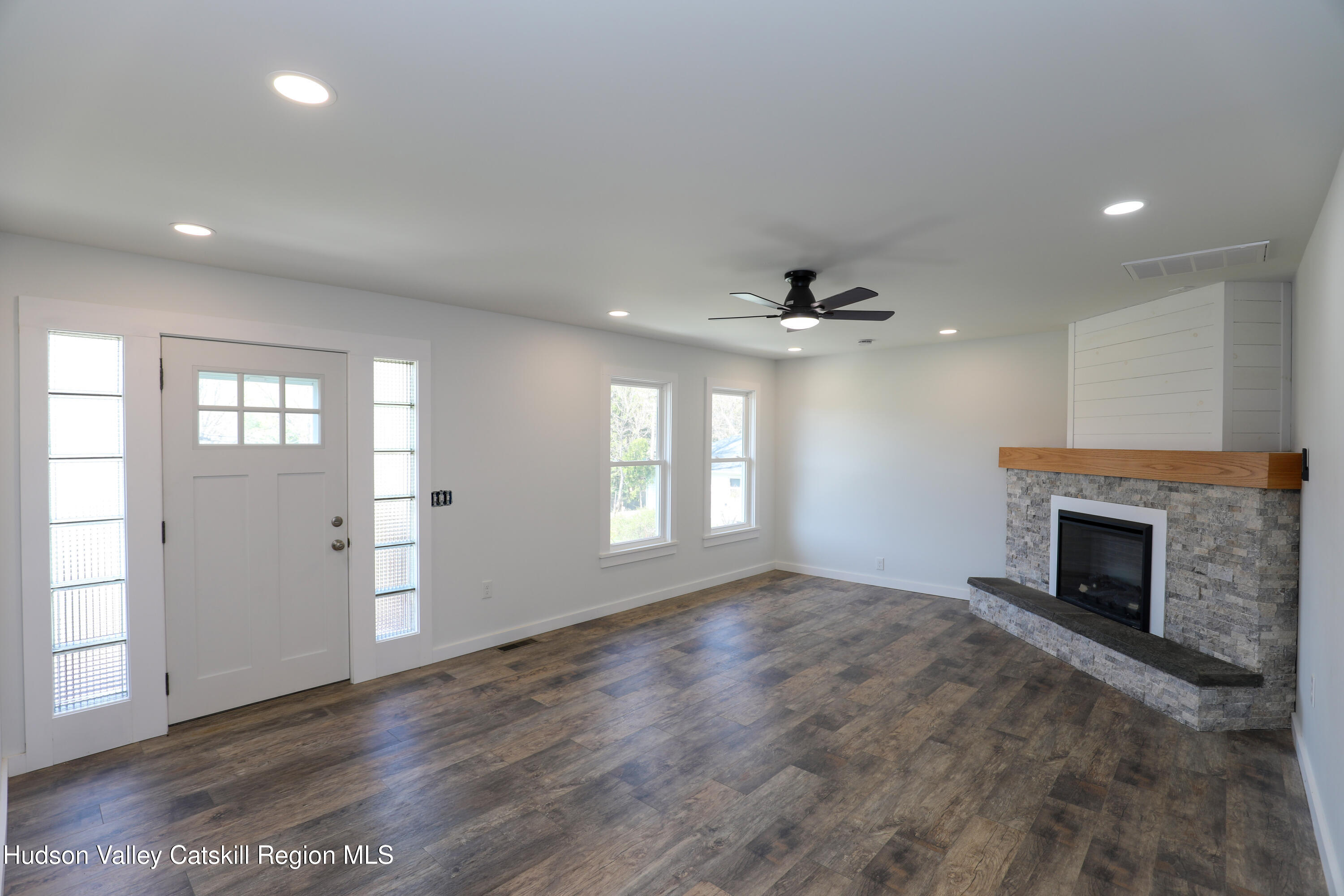 111 Zandhoek Road Hurley, NY 12443 - Photo 8 of 33 an empty room with windows and fireplace