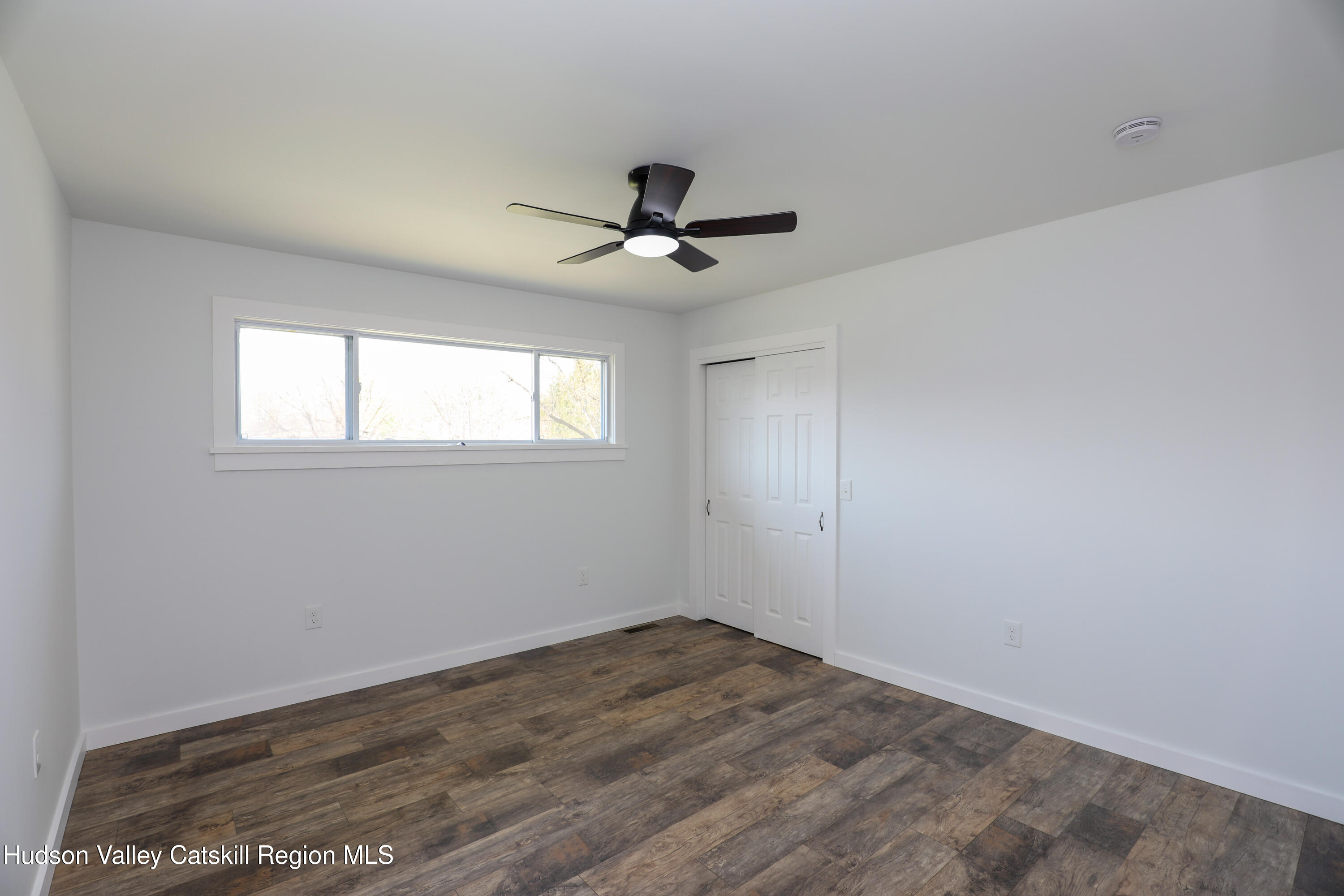 111 Zandhoek Road Hurley, NY 12443 - Photo 10 of 33 an empty room with wooden floor and ceiling fan