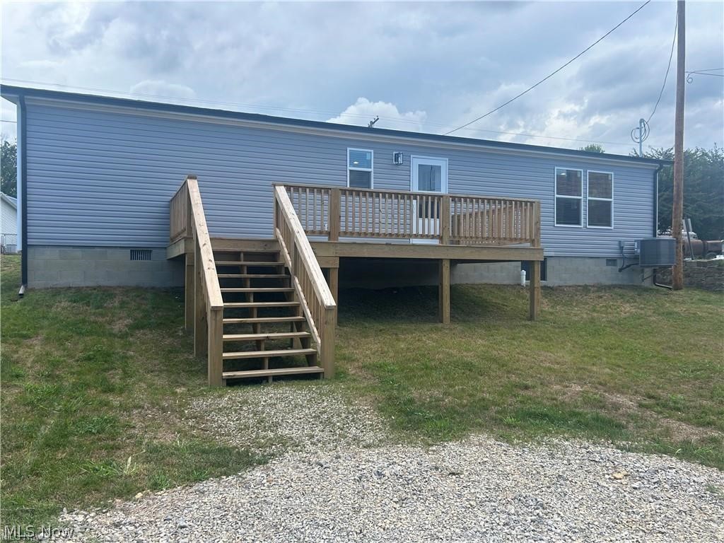 252 Front Street Philo, OH 43771 - Photo 16 of 17 Back of house with crawl space, a deck, and a lawn