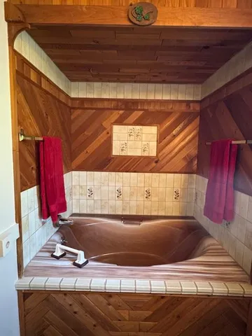a view of an empty room with furniture and a window