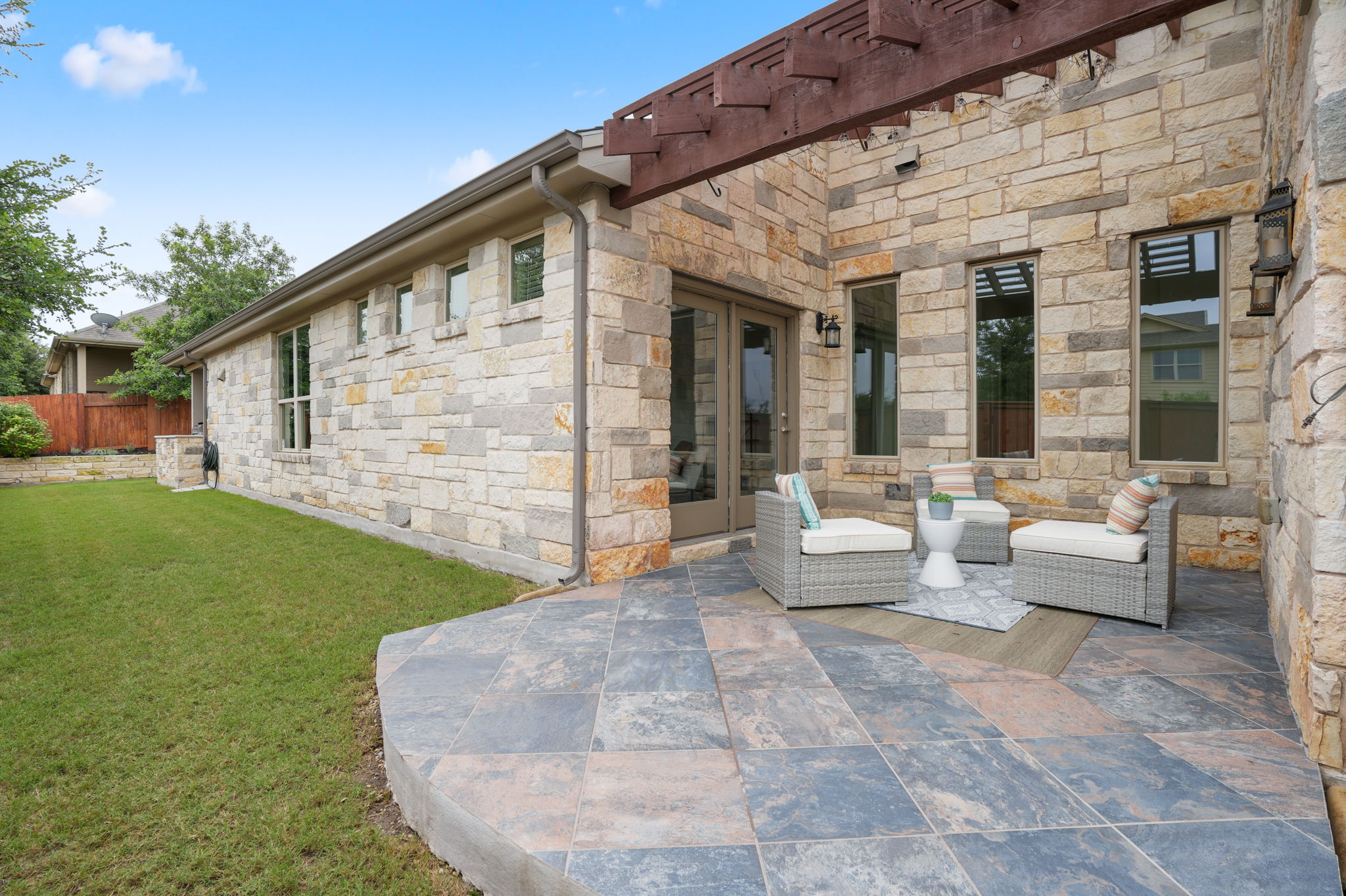 440 Cherokee Rose Circle Georgetown, TX 78626 - Photo 8 of 39 An inviting tiled patio with a pergola provides a perfect outdoor living space.