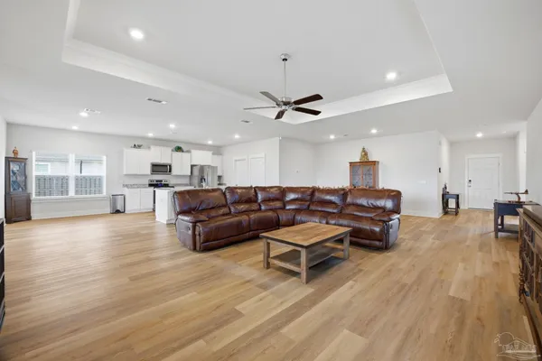 a living room with furniture and wooden floor
