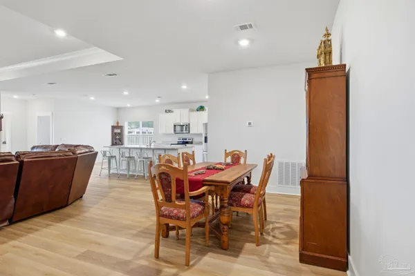 a view of a dining room with furniture and wooden floor