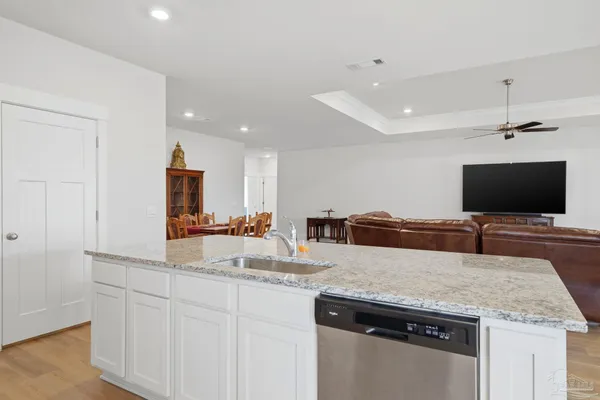 a kitchen with sink and view living room