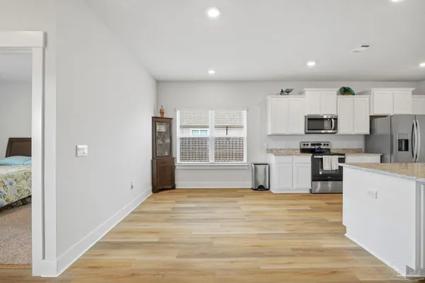a kitchen with stainless steel appliances granite countertop a stove and a refrigerator
