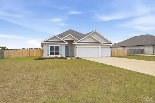 a front view of a house with a garden and yard