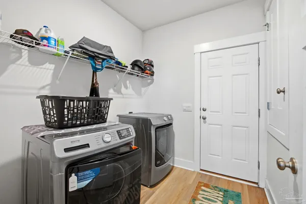 a view of a storage and utility room with washer and dryer