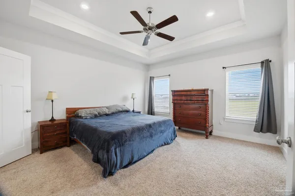 a bedroom with a bed and a ceiling fan