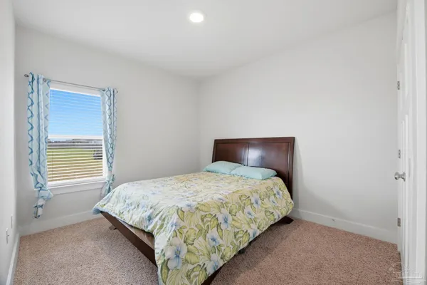 a bedroom with a bed and window