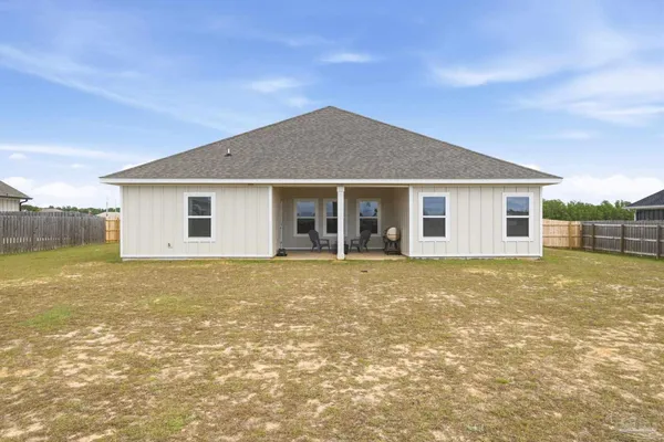 a view of a house with a backyard