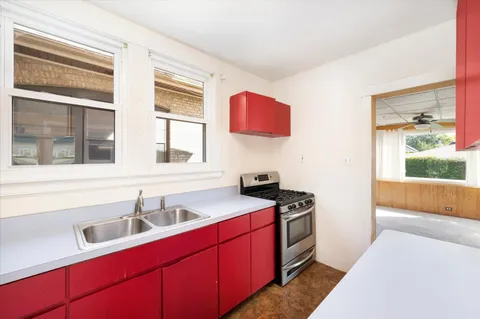 a kitchen that has a sink and a stove