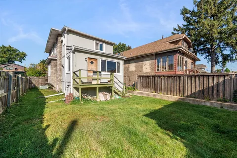 a view of a house with backyard and porch