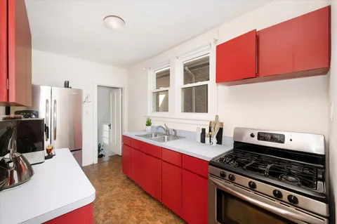 a kitchen with stainless steel appliances a stove a sink and a refrigerator