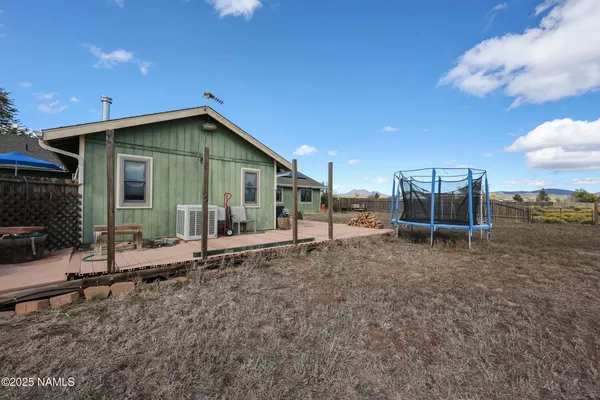 a view of a house with backyard and porch