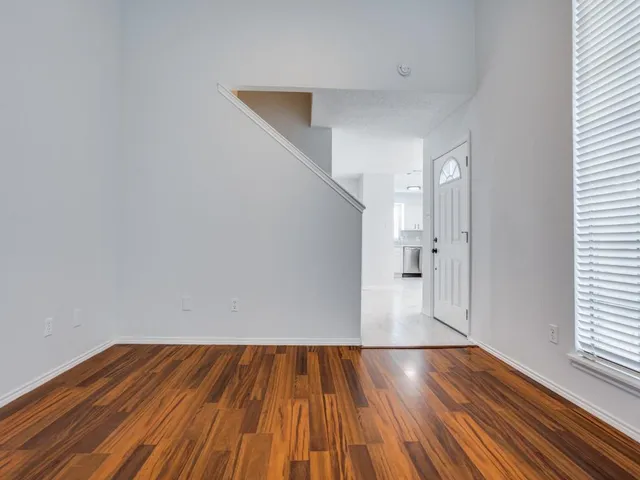 a view of a room with wooden floor and staircase