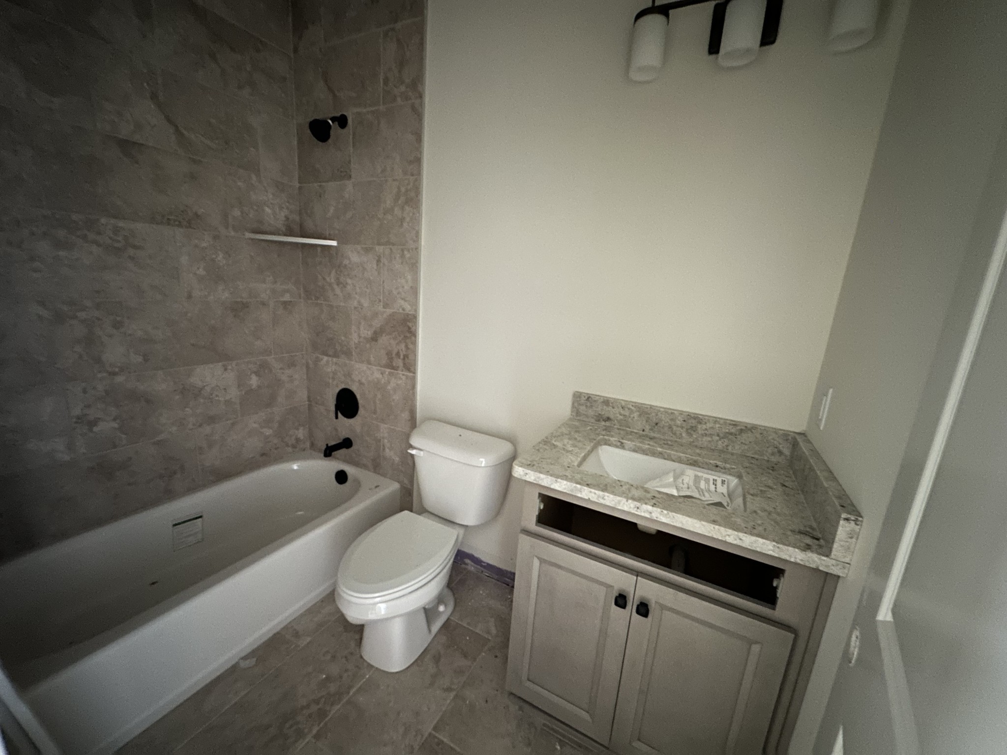 483 West Foxrun Springfield, TN 37172 - Photo 9 of 15 a bathroom with a granite countertop toilet a sink and bathtub