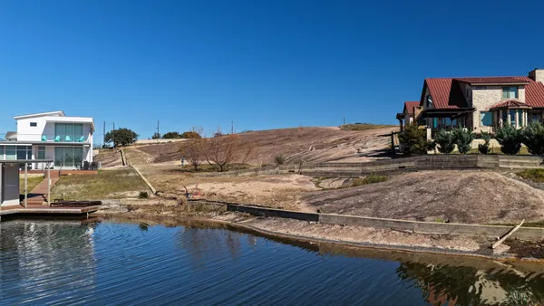 an aerial view of a house with outdoor space