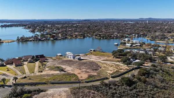 a view of a lake with houses in the back