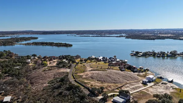 an aerial view of a house with a lake view