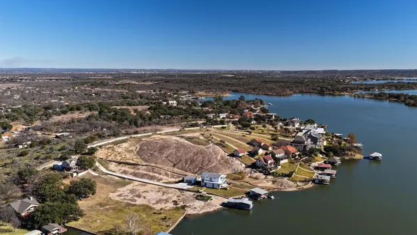 an aerial view of a house with a yard