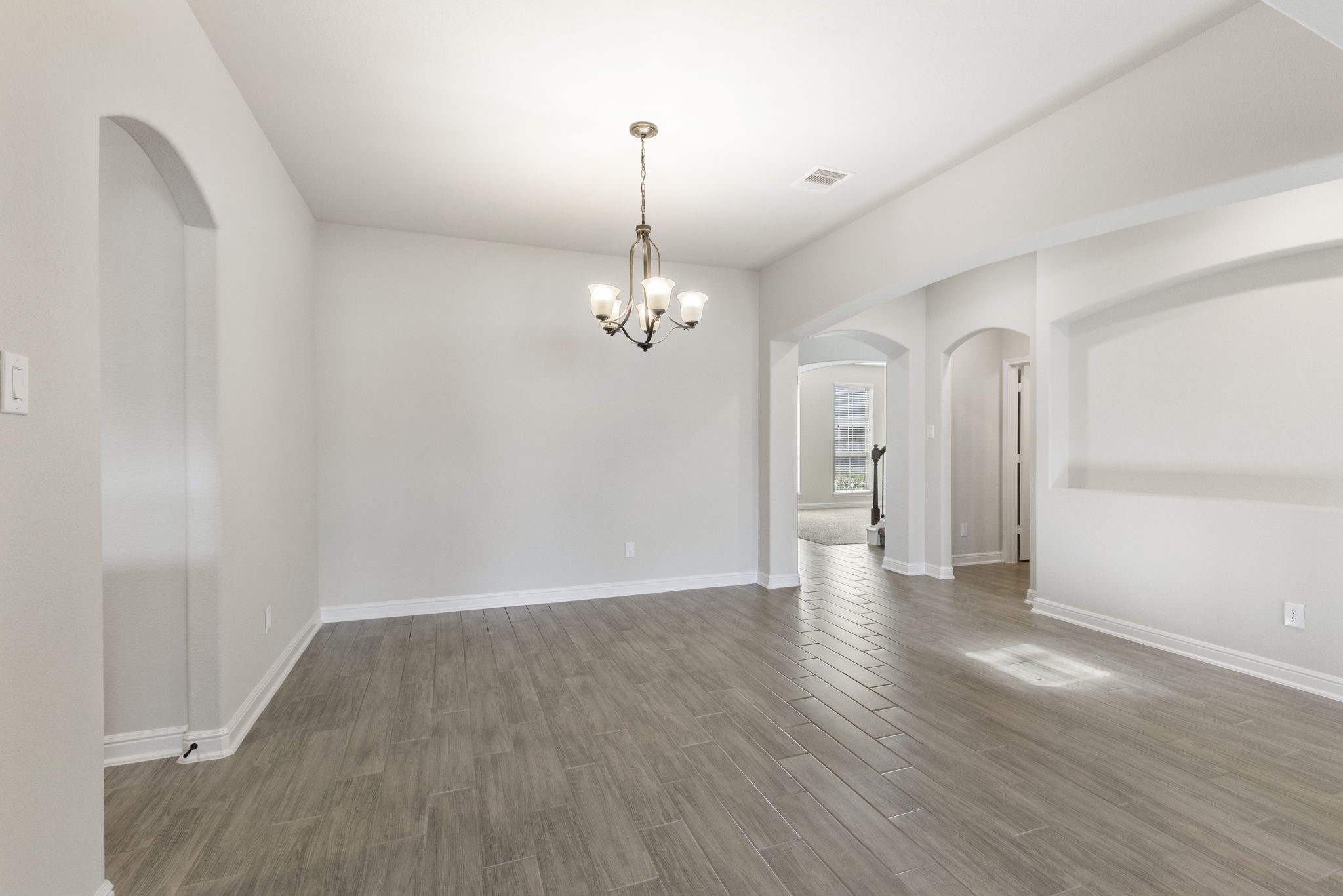 2819 Bradbury Hills Road Spring, TX 77373 - Photo 15 of 50 Experience elegance in this inviting formal dining room, featuring sleek flooring and a sophisticated chandelier, perfect for hosting memorable gatherings.