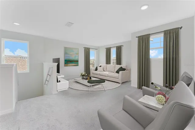 a living room with furniture and a large window