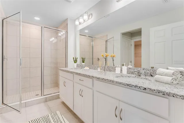 a bathroom with a granite countertop sink mirror and double