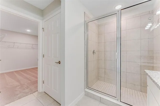 a bathroom with a glass shower door