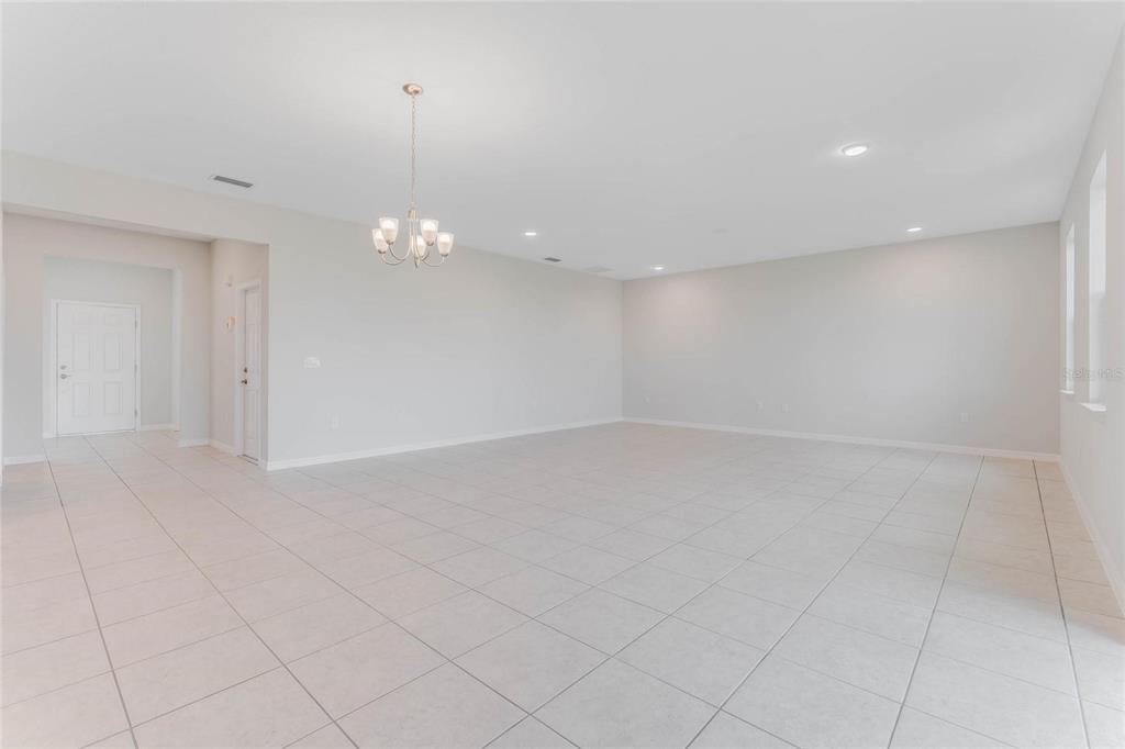 9592 Starling Loop Leesburg, FL 34788 - Photo 9 of 34 wooden floor in an empty room with a window
