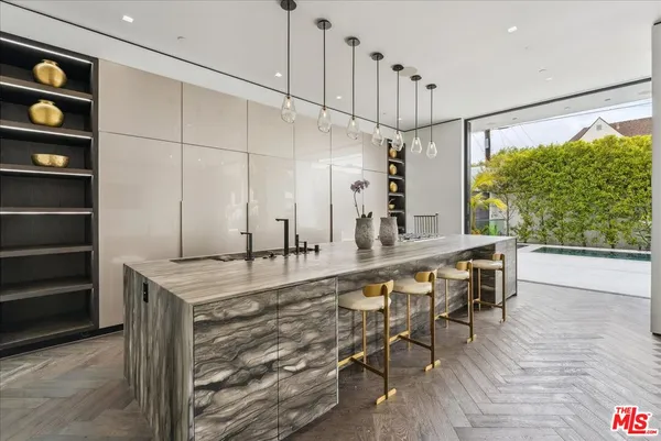 a kitchen with a table chairs refrigerator and sink